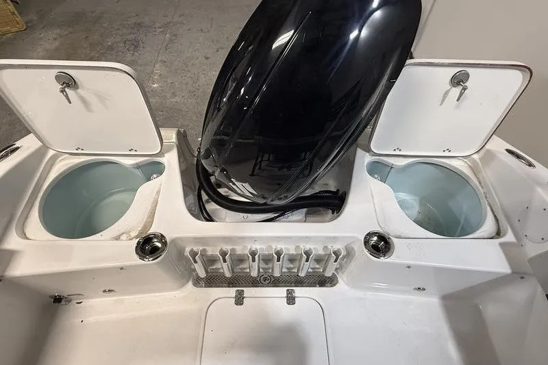 Slide: The Image of 2026 Sea Pro 202 Center Console boat with open storage compartments and engine. - 10