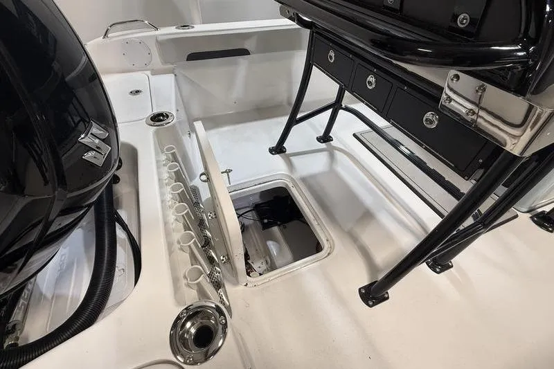 Slide: The Image of 2026 Sea Pro 202 Center Console boat interior with storage and rod holders. - 11