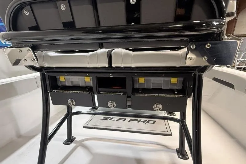 Slide: The Image of 2026 Sea Pro 202 Center Console boat interior with storage compartments and seating. - 14