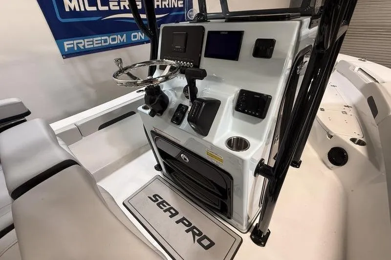 Slide: The Image of 2026 Sea Pro 202 Center Console boat interior with modern dashboard and steering wheel. - 15