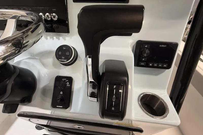 Slide: The Image of 2026 Sea Pro 202 Center Console boat controls with steering wheel and throttle. - 17
