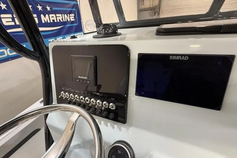 Slide: The Image of 2026 Sea Pro 202 Center Console dashboard with Suzuki and Simrad displays. - 18