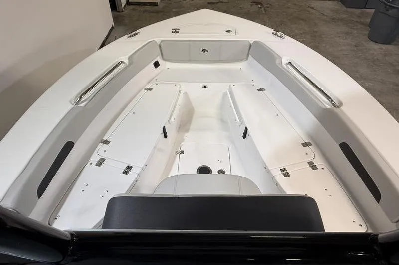 Slide: The Image of 2026 Sea Pro 202 Center Console boat interior with white seating and storage compartments. - 31