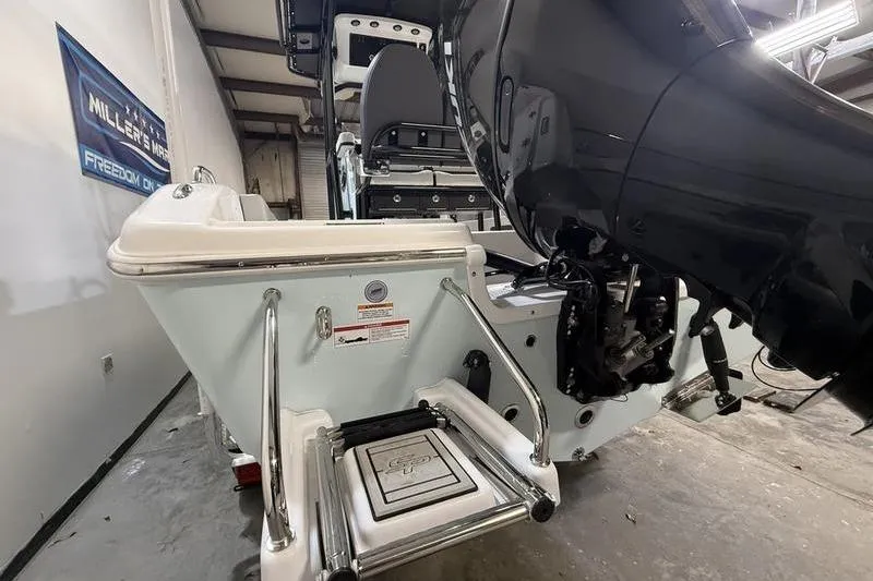 Slide: The Image of 2026 Sea Pro 202 Center Console boat with powerful outboard motor in a garage setting. - 6