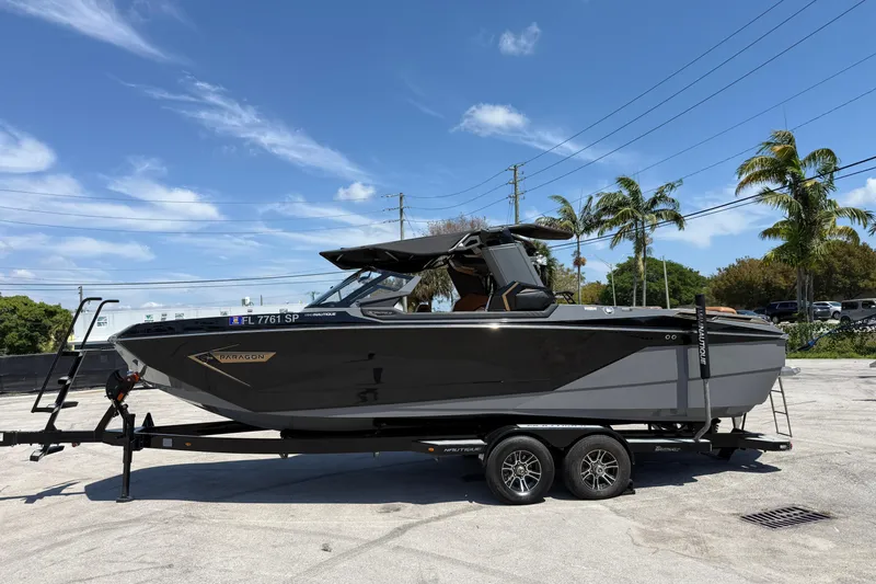 The Image of 2020 Nautique Super Air Nautique G25 Paragon boat on trailer, parked outdoors. - 1