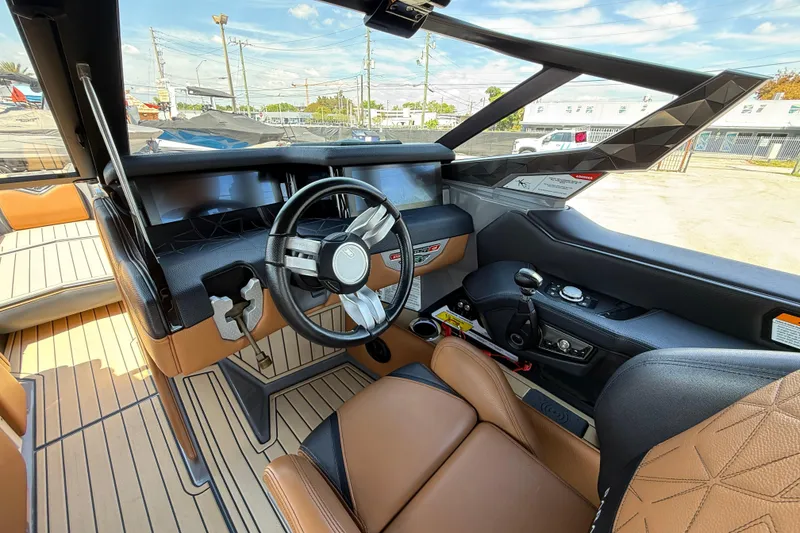 Slide: The Image of 2020 Nautique Super Air Nautique G25 Paragon cockpit with luxury seating and advanced controls. - 11
