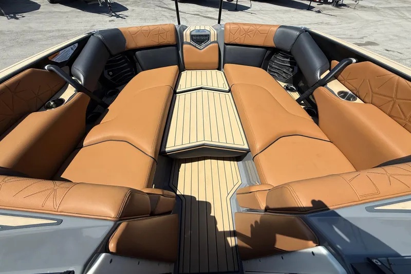Slide: The Image of 2020 Nautique Super Air Nautique G25 Paragon interior with tan leather seating and teak flooring. - 12