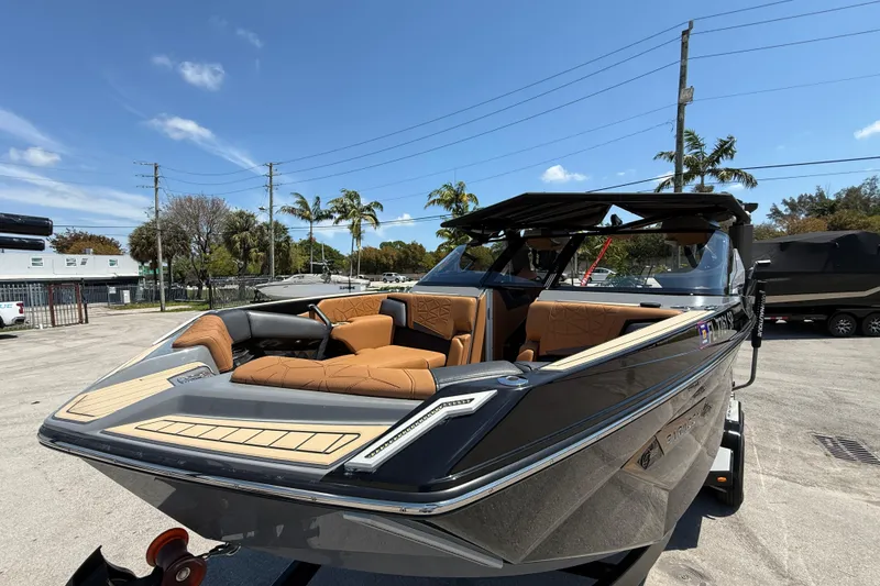 Slide: The Image of 2020 Nautique Super Air Nautique G25 Paragon boat with luxurious seating, parked outdoors. - 3