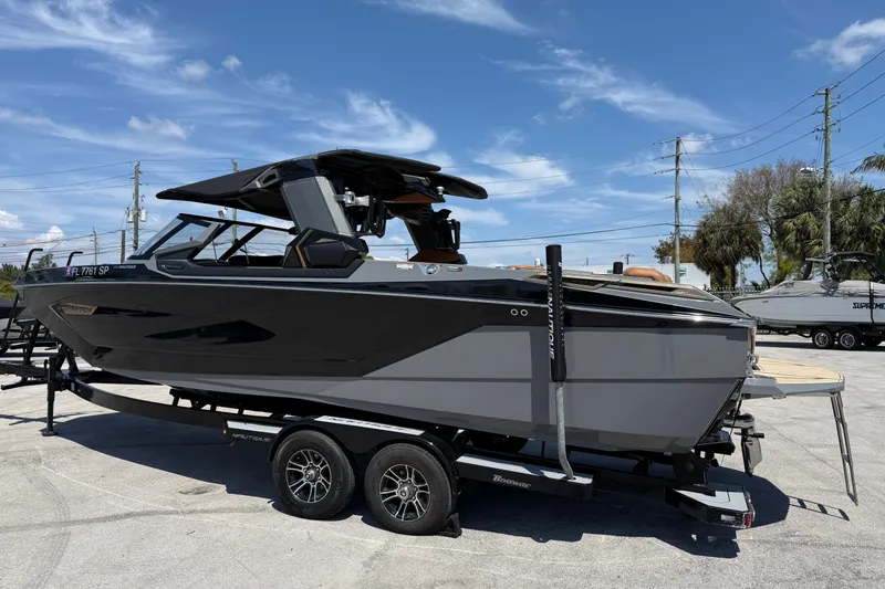 Slide: The Image of 2020 Nautique Super Air Nautique G25 Paragon boat on trailer under clear blue sky. - 4