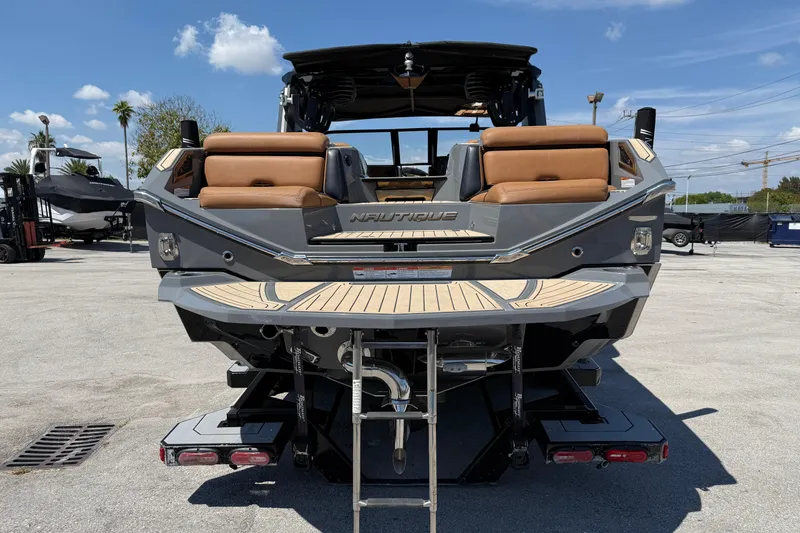 Slide: The Image of 2020 Nautique Super Air Nautique G25 Paragon boat rear view with teak deck. - 5