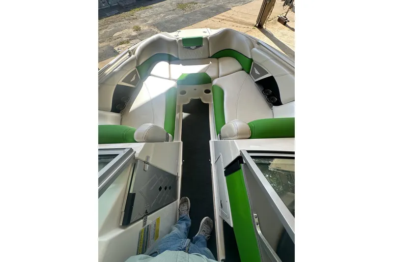 Slide: The Image of 2013 MasterCraft X55 boat interior with green and white seating, viewed from above. - 5