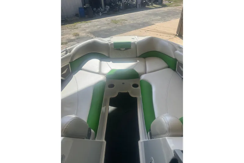 Slide: The Image of 2013 MasterCraft X55 boat interior with green and white seating. - 6