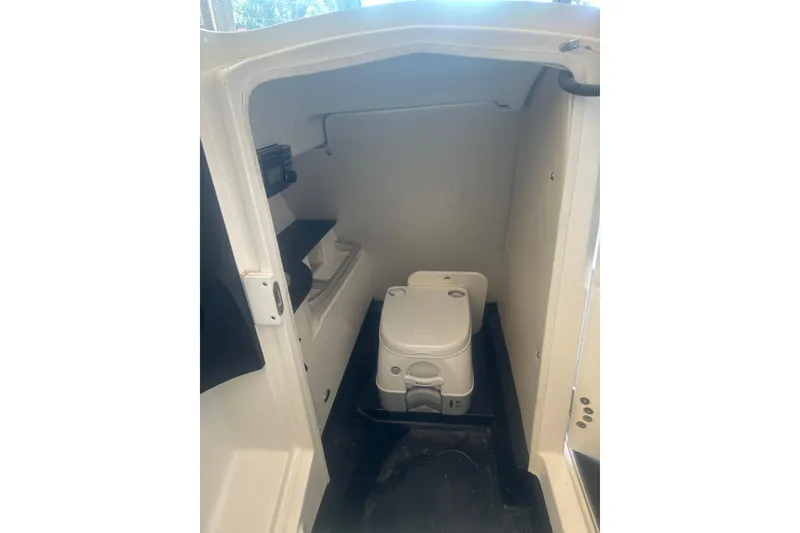 Slide: The Image of 2013 MasterCraft X55 boat interior with compact marine toilet. - 7