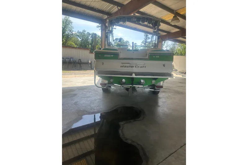 Slide: The Image of 2013 MasterCraft X55 boat in a covered storage area, rear view. - 9