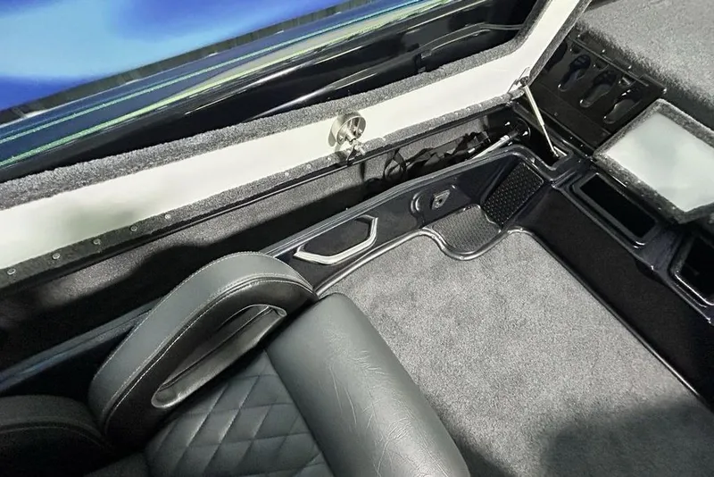 Slide: The Image of Interior of 2026 Phoenix 819 ZXL boat with sleek seating and storage compartments. - 13