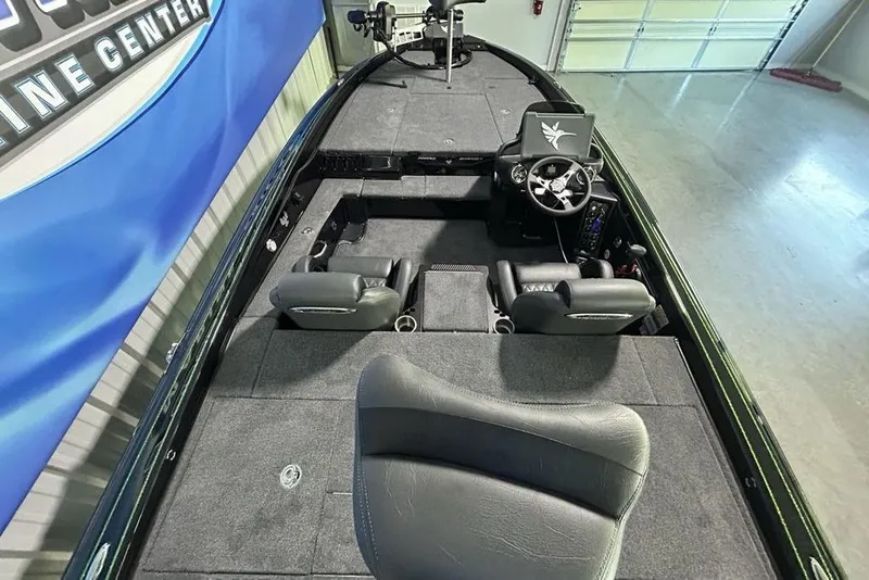Slide: The Image of 2026 Phoenix 819 ZXL boat interior with steering wheel and seating in a showroom. - 15