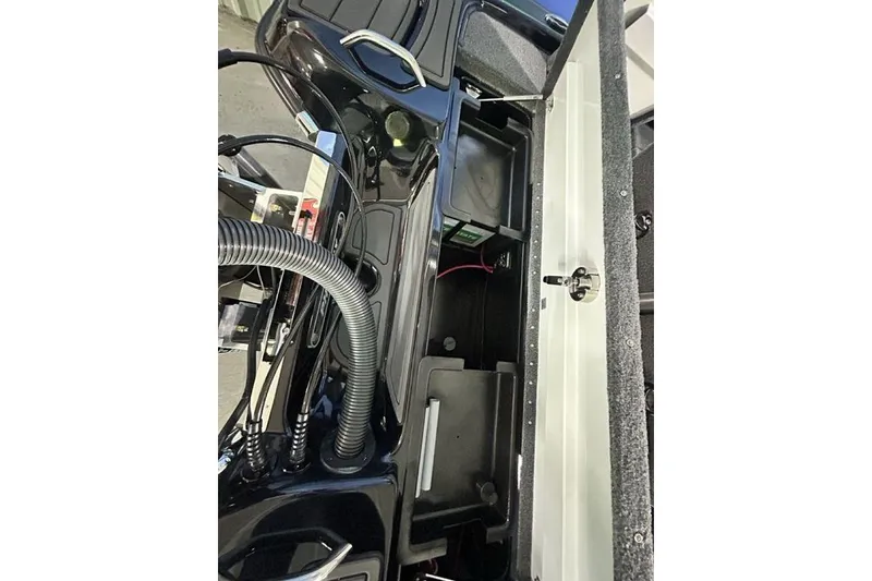 Slide: The Image of 2026 Phoenix 819 ZXL boat interior showing storage compartment and wiring. - 18