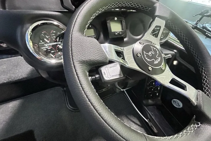 Slide: The Image of Steering wheel and dashboard of 2026 Phoenix 819 ZXL with gauges and logo. - 4