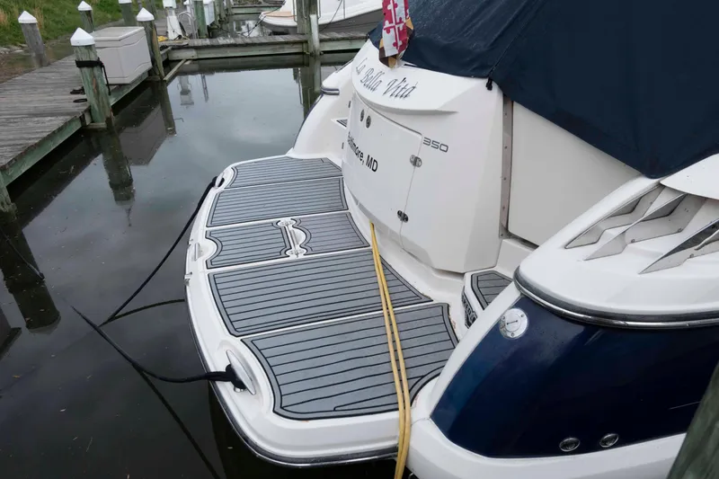 Slide: The Image of 2008 Monterey 350 Sport Yacht docked, featuring sleek design and spacious swim platform. - 11