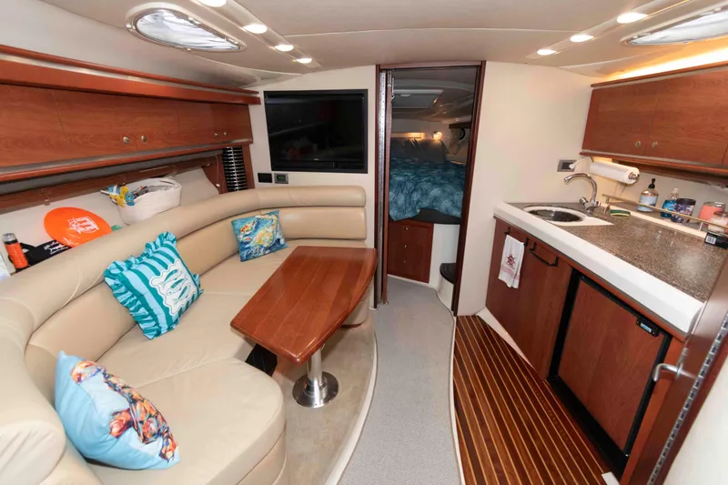Slide: The Image of Interior of 2008 Monterey 350 Sport Yacht with cozy seating and kitchenette. - 12