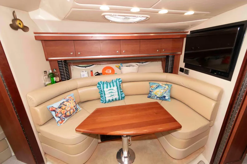 Slide: The Image of Luxurious interior of 2008 Monterey 350 Sport Yacht with plush seating and wooden table. - 13