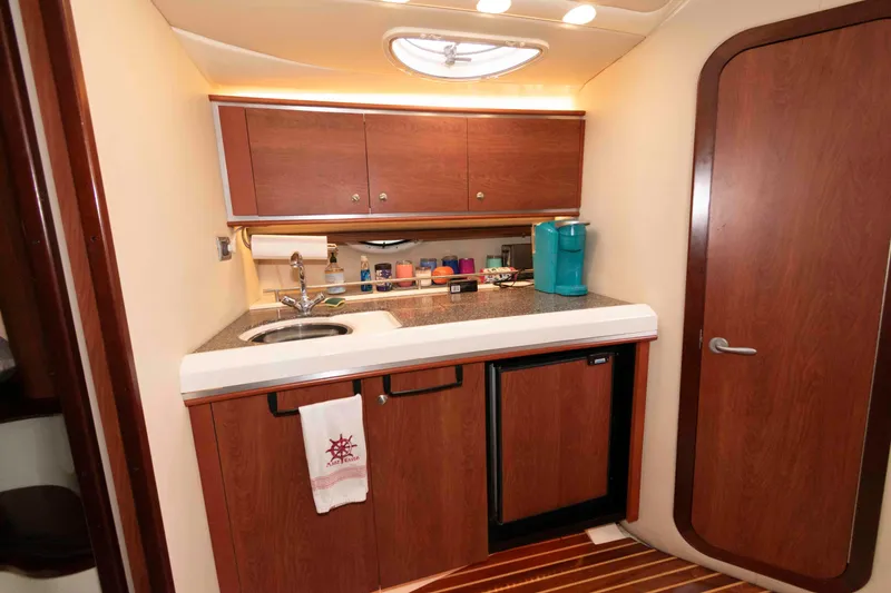 Slide: The Image of 2008 Monterey 350 Sport Yacht kitchen with wood cabinets, sink, and compact appliances. - 14
