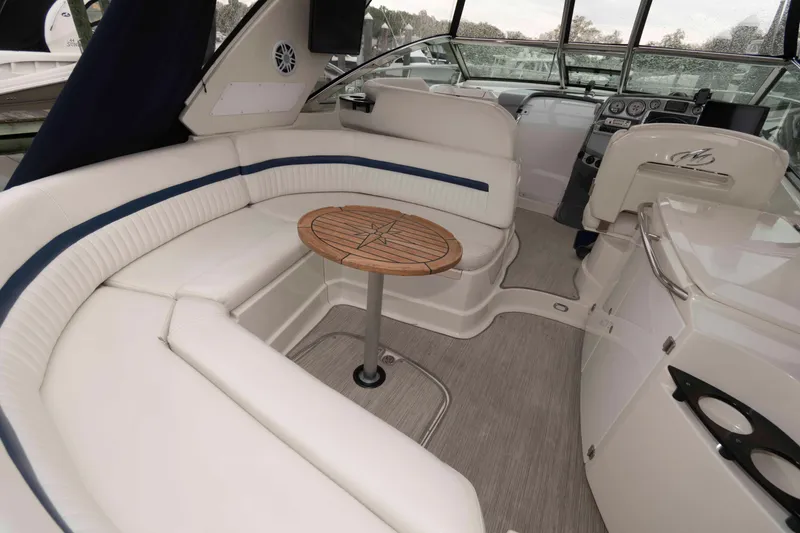Slide: The Image of 2008 Monterey 350 Sport Yacht interior with white seating and wooden table. - 3