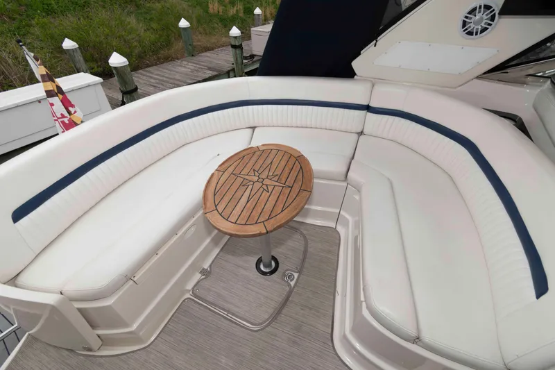 Slide: The Image of 2008 Monterey 350 Sport Yacht interior with curved seating and wooden table. - 4