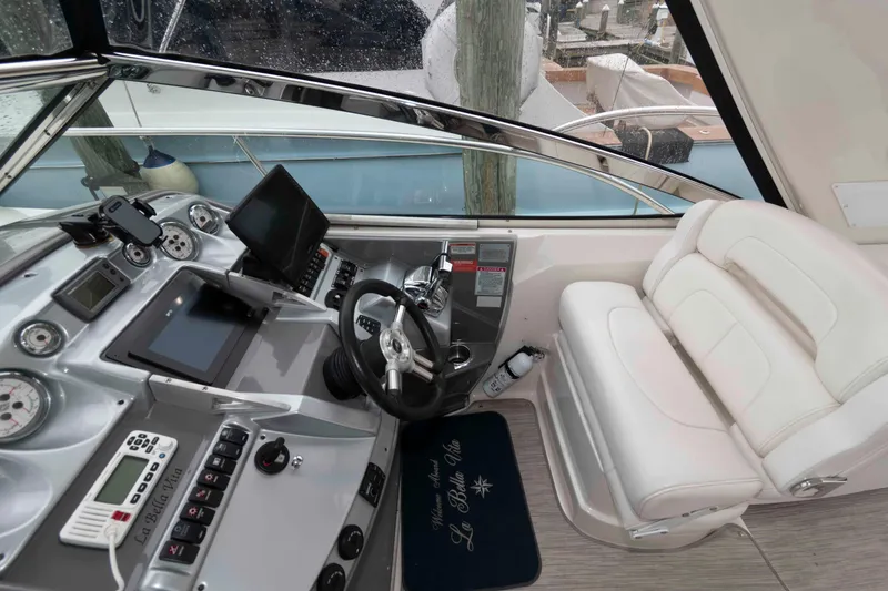 Slide: The Image of Cockpit of 2008 Monterey 350 Sport Yacht with modern controls and white seating. - 6