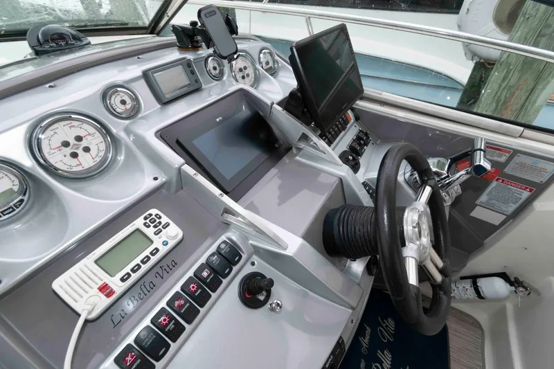 Slide: The Image of 2008 Monterey 350 Sport Yacht helm with gauges, steering wheel, and navigation equipment. - 7