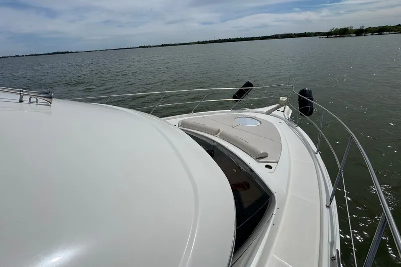 Slide: The Image of 2003 Silverton 39 Motor Yacht cruising on a calm lake under a clear sky. - 10