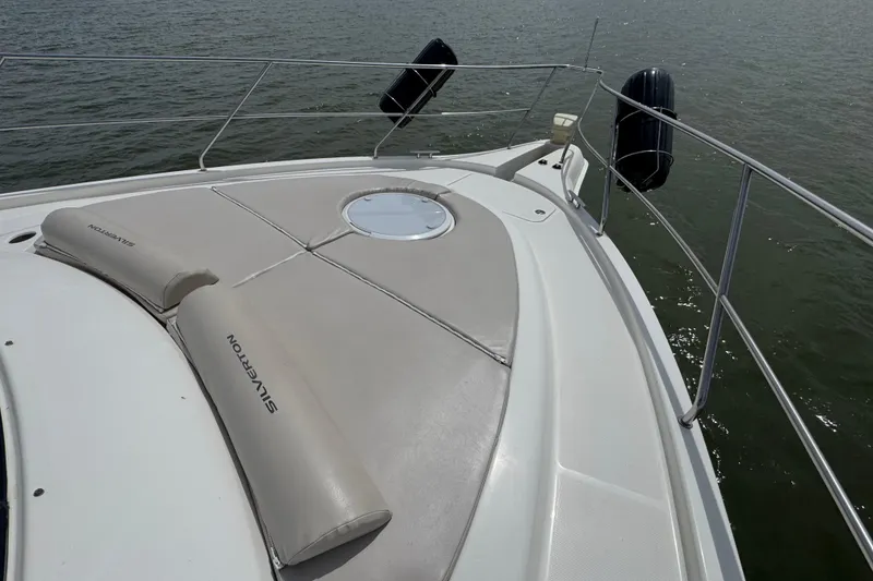 Slide: The Image of 2003 Silverton 39 Motor Yacht deck with cushioned seating and railing, overlooking water. - 11