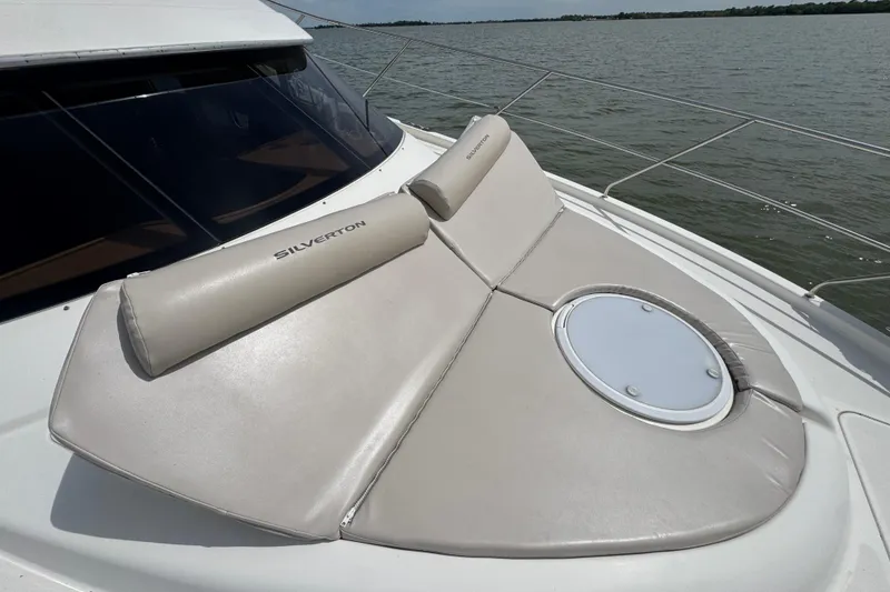 Slide: The Image of 2003 Silverton 39 Motor Yacht with cushioned sunbathing area on deck. - 14