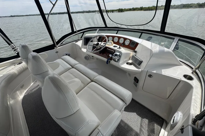 Slide: The Image of 2003 Silverton 39 Motor Yacht helm with dual seats and panoramic water view. - 16