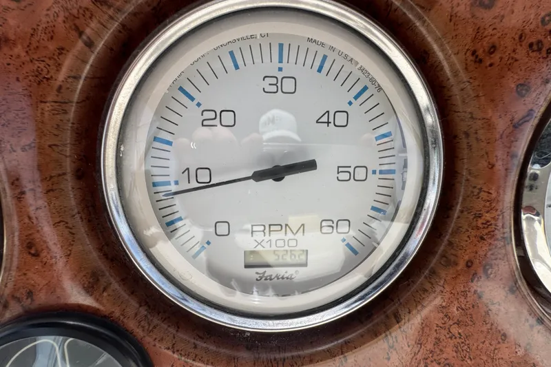 Slide: The Image of Tachometer of 2003 Silverton 39 Motor Yacht displaying RPM on wooden dashboard. - 18
