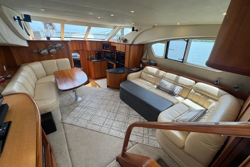 Slide: The Image of Luxurious interior of 2003 Silverton 39 Motor Yacht with plush seating and elegant wood finishes. - 22