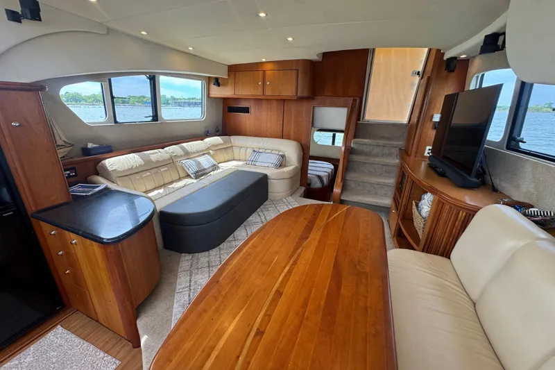 Slide: The Image of Luxurious interior of 2003 Silverton 39 Motor Yacht with elegant wood finishes and comfortable seating. - 23