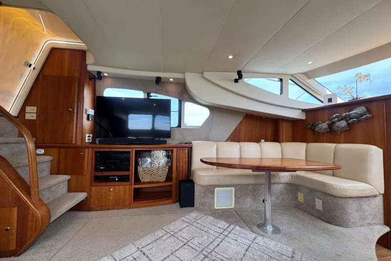 Slide: The Image of Luxurious interior of 2003 Silverton 39 Motor Yacht with TV, seating, and wooden accents. - 29