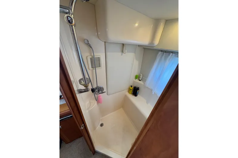 Slide: The Image of Shower area in 2003 Silverton 39 Motor Yacht with toiletries and curtain. - 32
