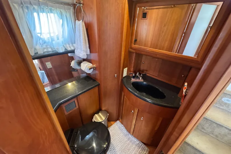 Slide: The Image of Luxurious bathroom in 2003 Silverton 39 Motor Yacht with wood accents and modern fixtures. - 33