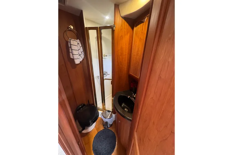 Slide: The Image of Bathroom interior of 2003 Silverton 39 Motor Yacht with wood paneling and compact design. - 40