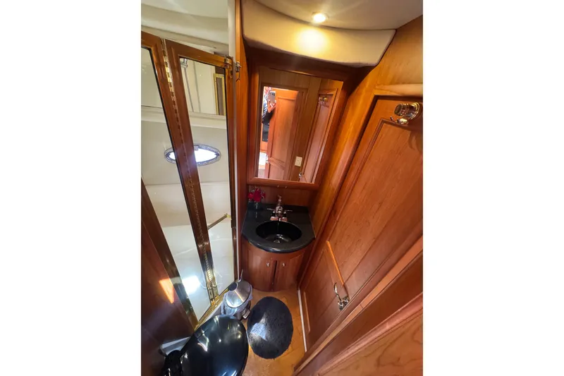Slide: The Image of Luxurious bathroom interior of 2003 Silverton 39 Motor Yacht with wood accents and modern fixtures. - 42