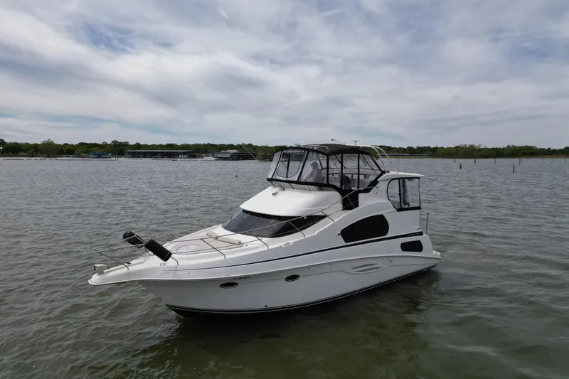Slide: The Image of 2003 Silverton 39 Motor Yacht on calm waters under a cloudy sky. - 5