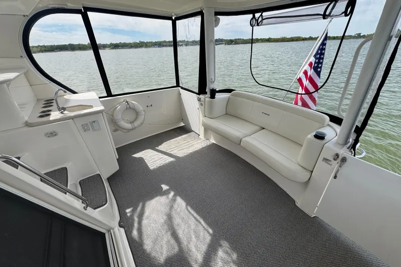 Slide: The Image of 2003 Silverton 39 Motor Yacht interior with seating, sink, and American flag. - 7