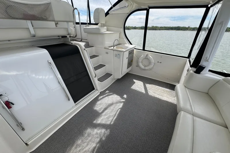 Slide: The Image of Interior of 2003 Silverton 39 Motor Yacht with seating, kitchenette, and lake view. - 8