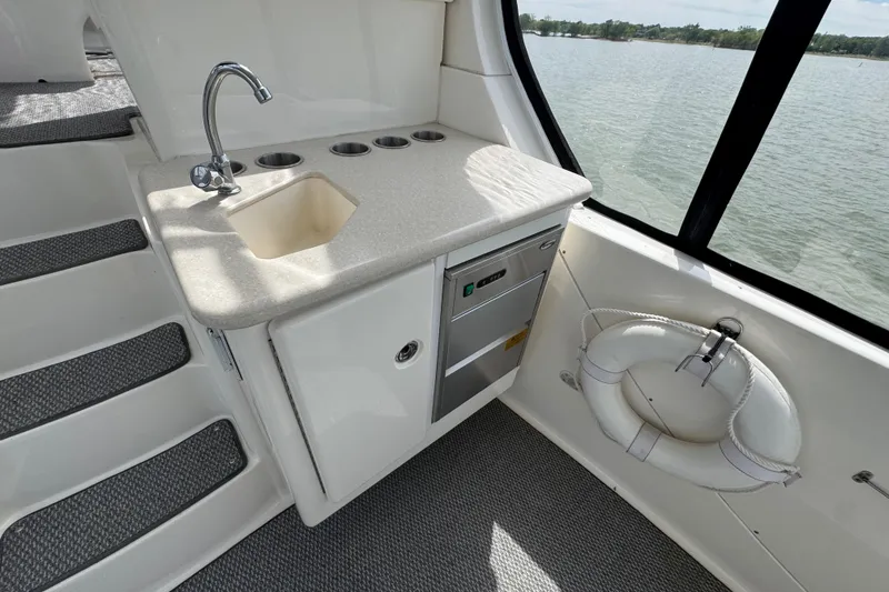 Slide: The Image of 2003 Silverton 39 Motor Yacht interior with sink, countertop, and life preserver by window. - 9