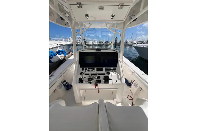 Slide: The Image of 2016 Regulator 34 Center Console boat interior with steering wheel and navigation system. - 17