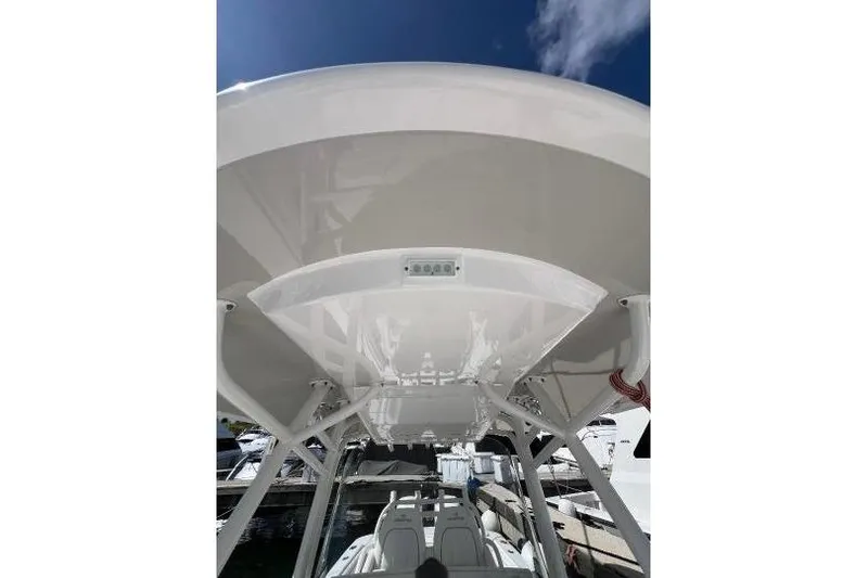 Slide: The Image of 2016 Regulator 34 Center Console boat, view of the T-top and seating area. - 6