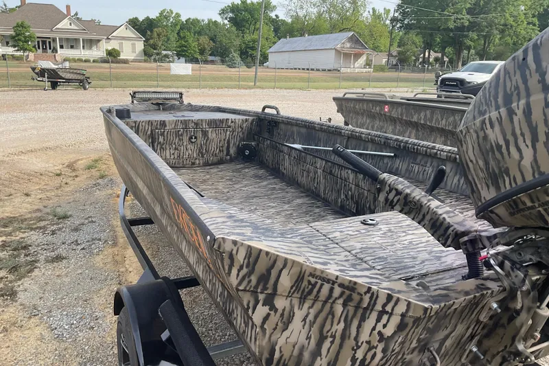 Slide: The Image of 2026 Excel Eclipse 1754 boat with camouflage design on a trailer, parked outdoors. - 3