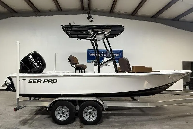 The Image of 2026 Sea Pro 210 Bay boat on trailer in indoor showroom. - 0